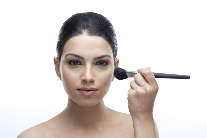 elegant portrait of a girl applying make-up