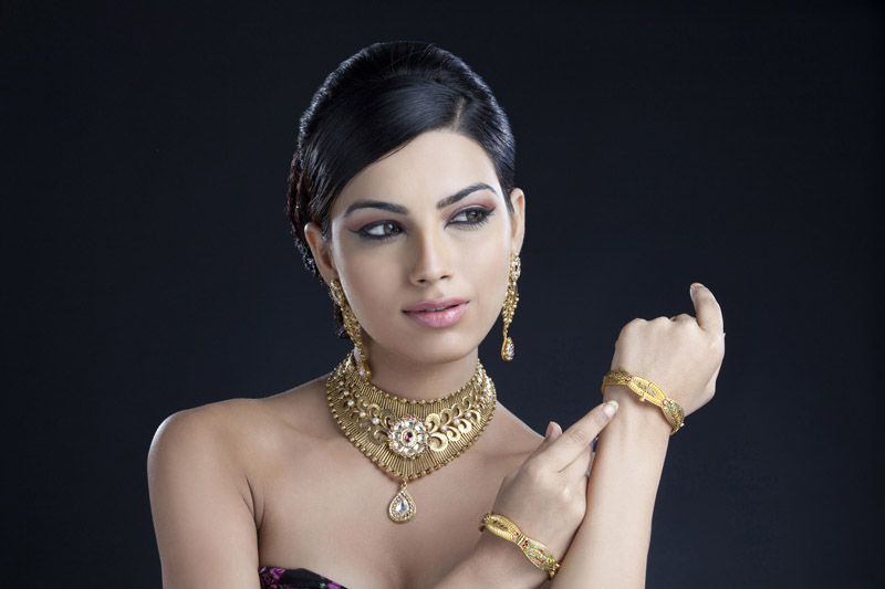 woman flaunting her gold jewellery 