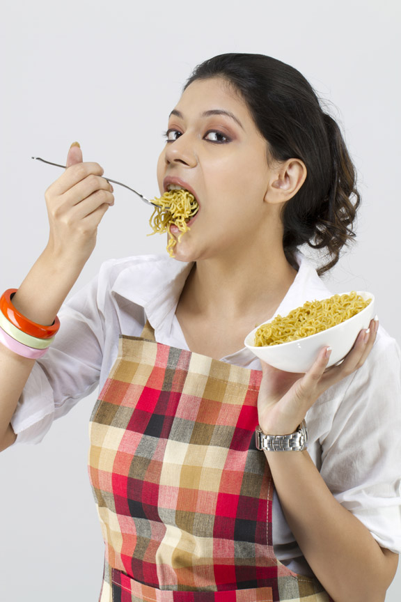 girl eating a bowl of noodles