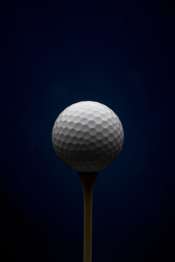 Golf ball with dark blue background