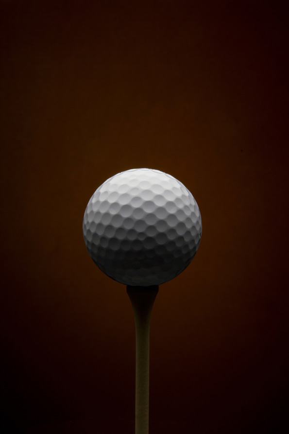 Golf ball with brown background