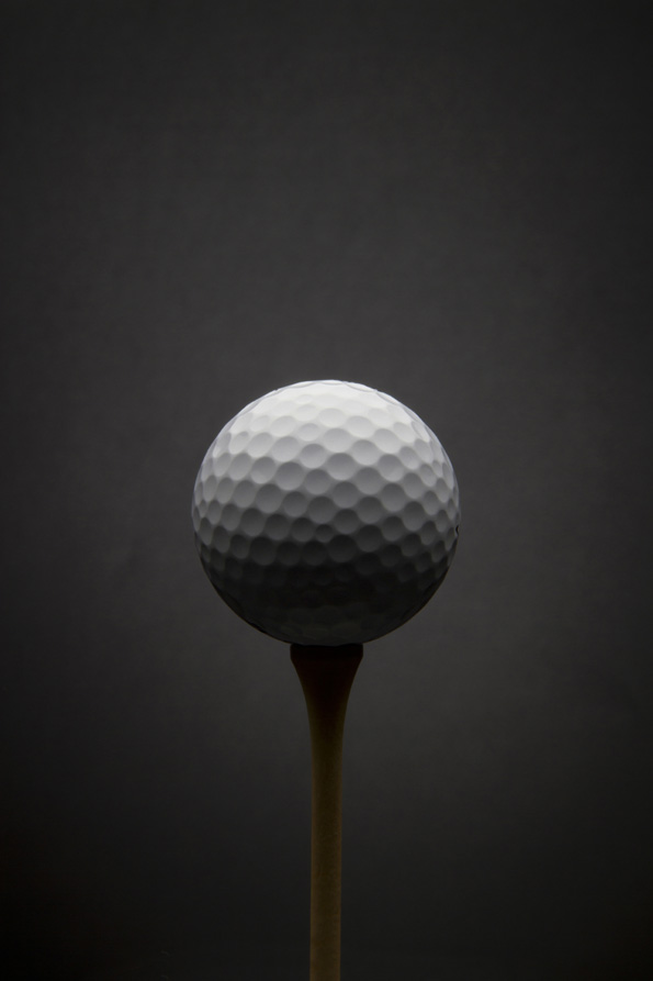 Golf ball with dark grey background