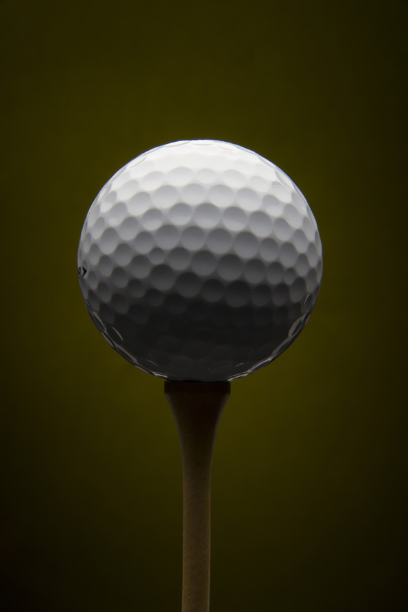 Golf ball with olive background