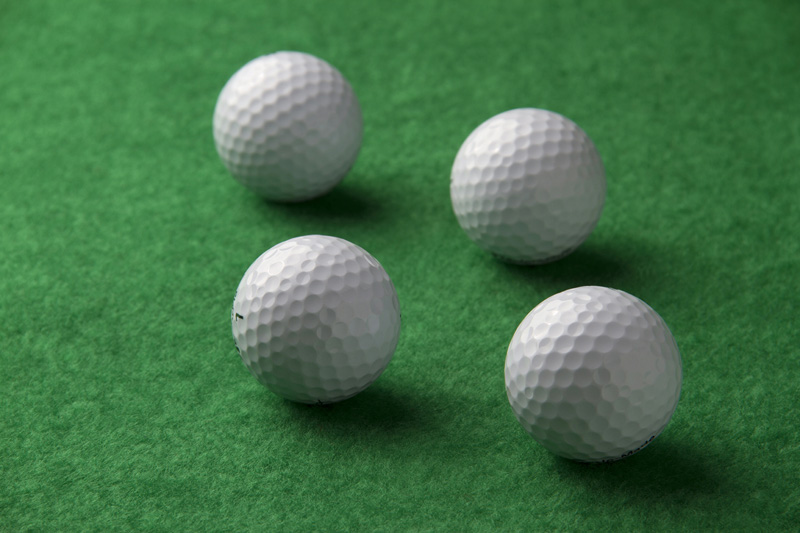 golf balls on a green background