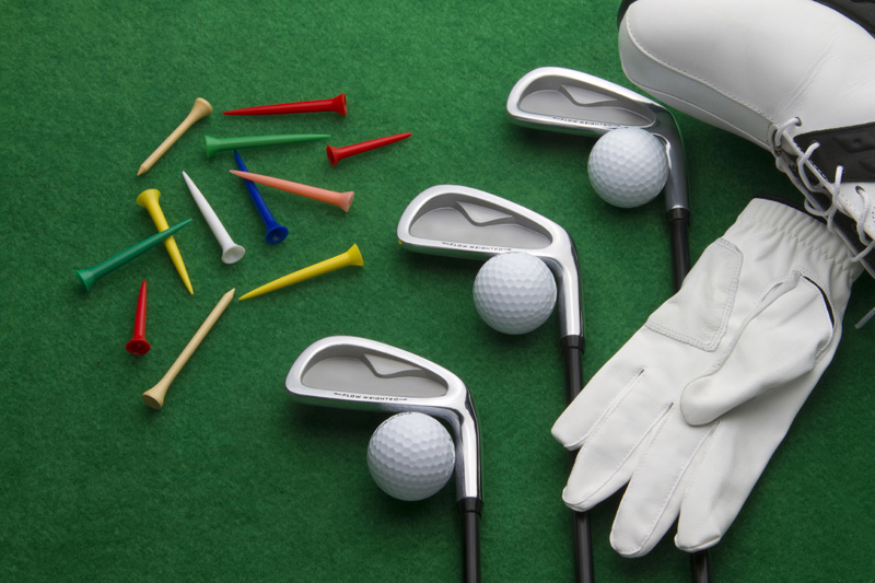 golf accessories on green background
