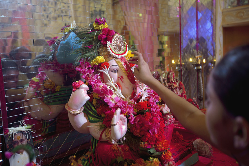 woman in the lord ganesha temple performing puja 