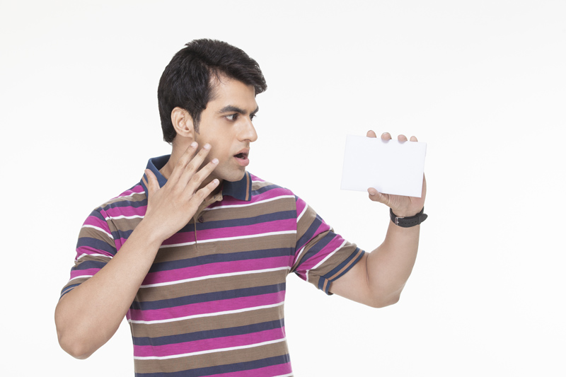 man posing with a white card