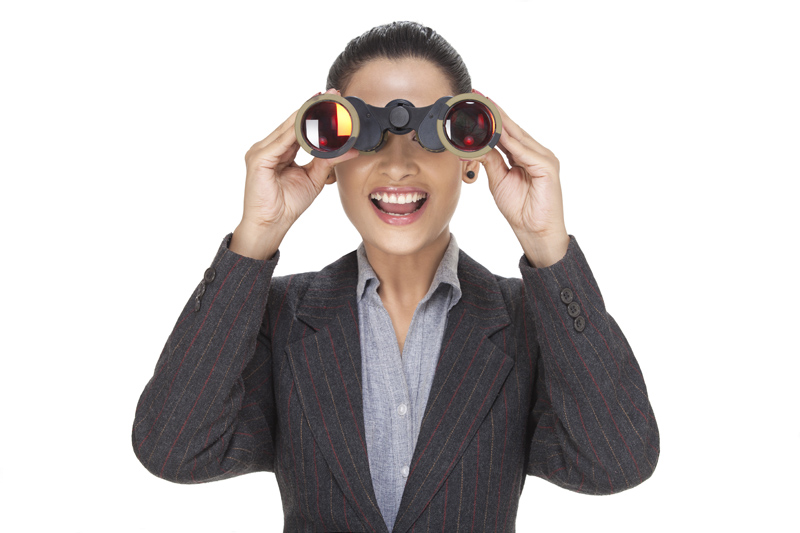 woman laughing while looking at something with binocular