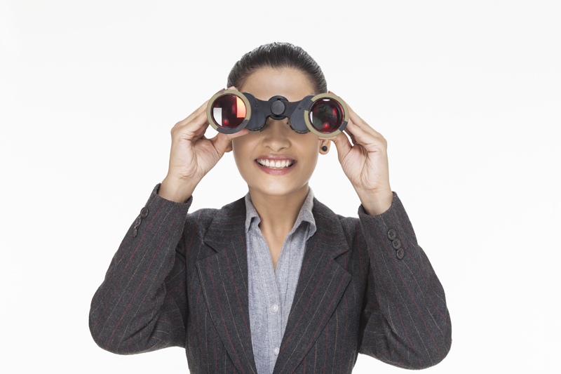 woman smiling while looking with binocular 
