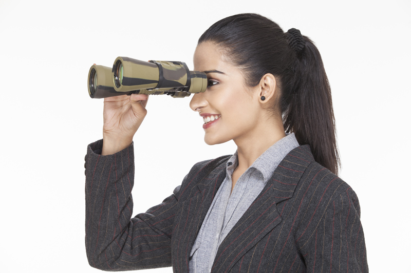 corporate woman looking through binocular