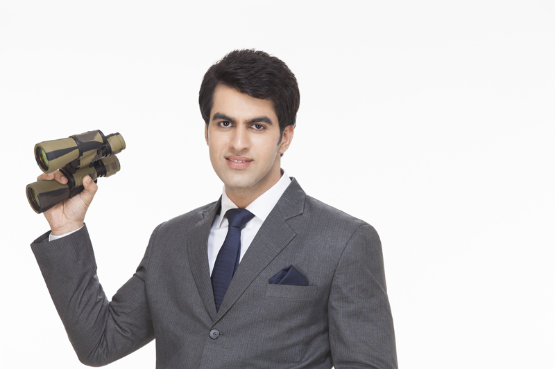 businessman posing with binoculars