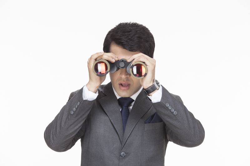 businessman in surprise after looking something from binoculars 
