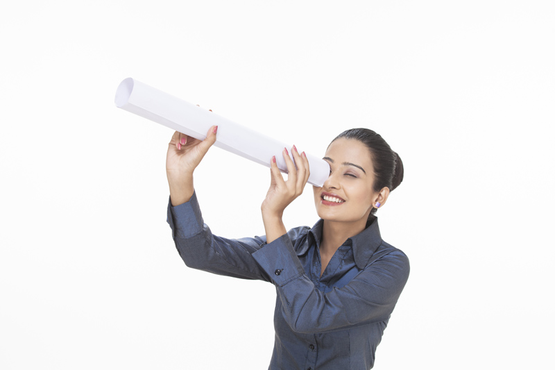 girl using rolled chart as telescope