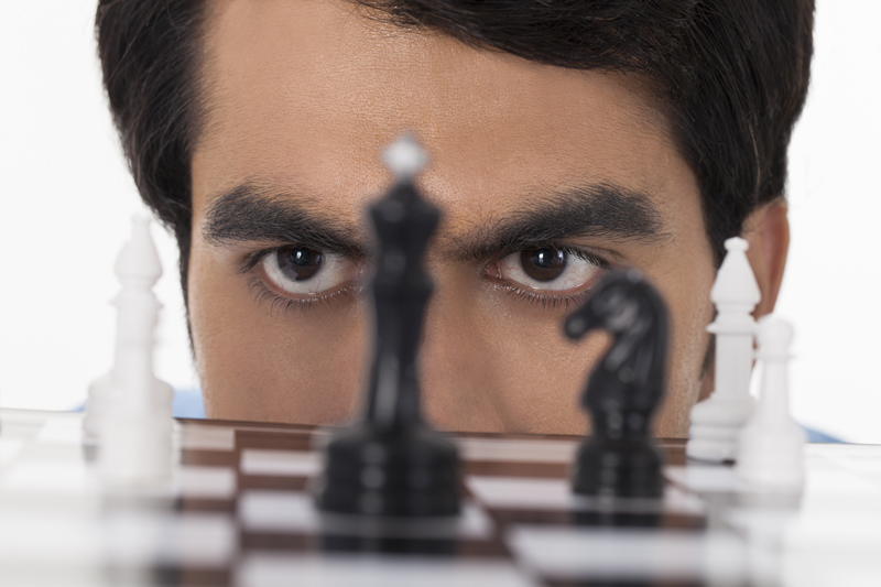 man looking at chess