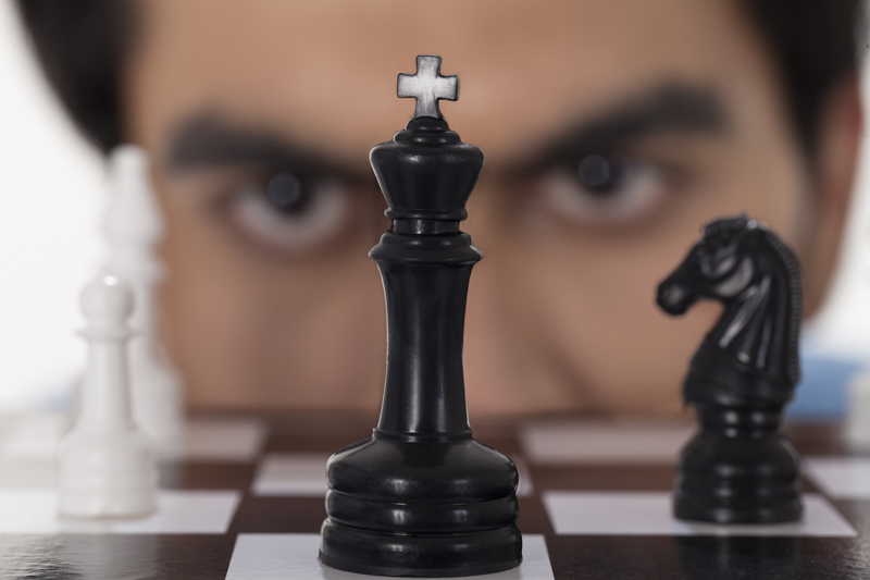 man staring at chess board