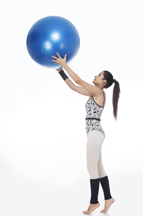 girl exercising with fitness ball
