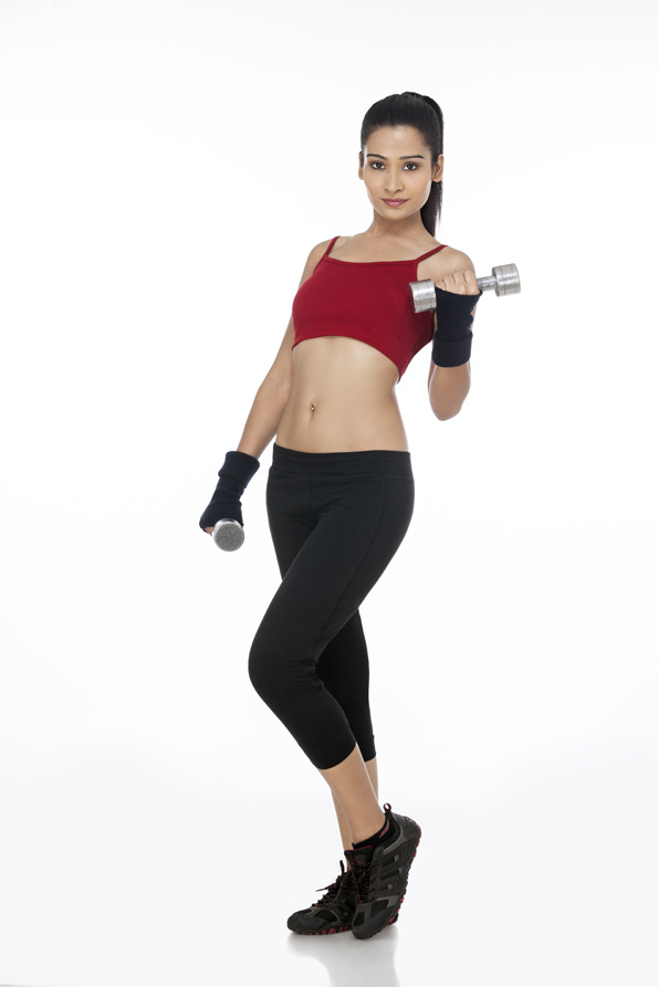 girl posing with dumbbells