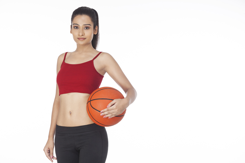 girl with basketball posing 