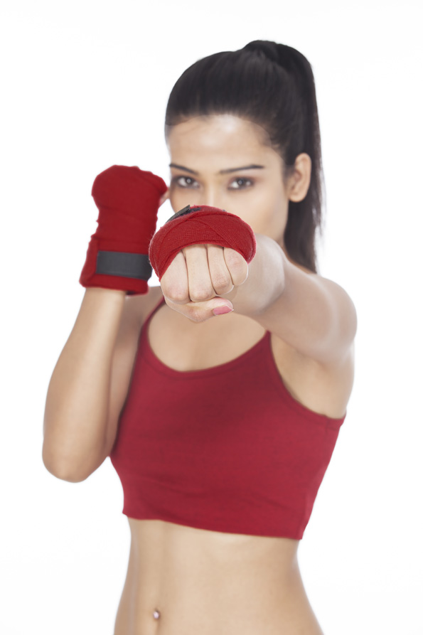 girl punching in front of camera 