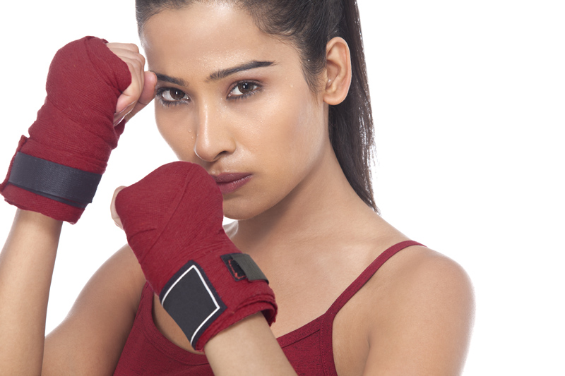 girl wearing gloves posing in self defense 