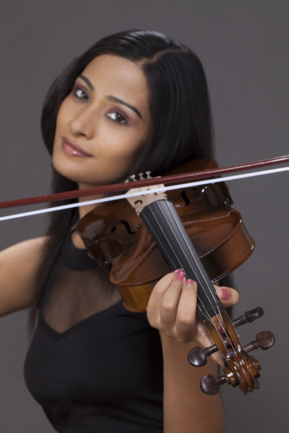 girl posing while playing violin