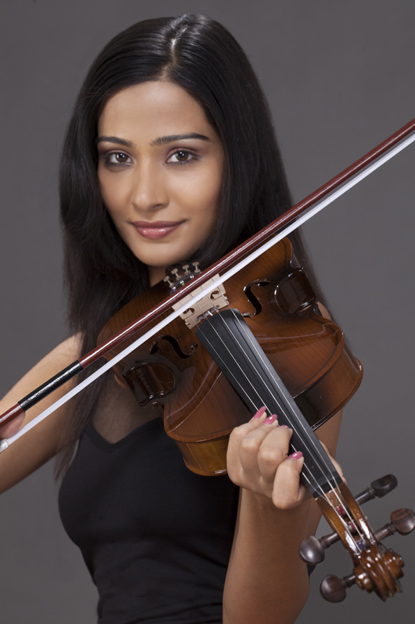 girl smiling and playing violin