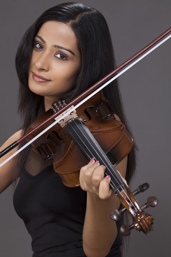 girl playing violin and posing