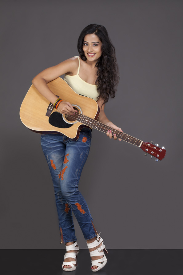 girl playing guitar and posing