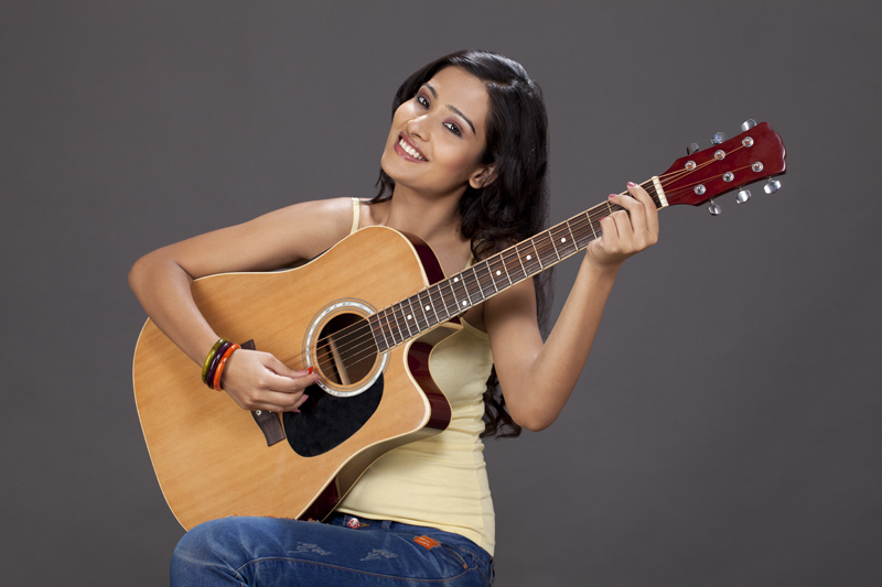 girl playing guitar and posing 