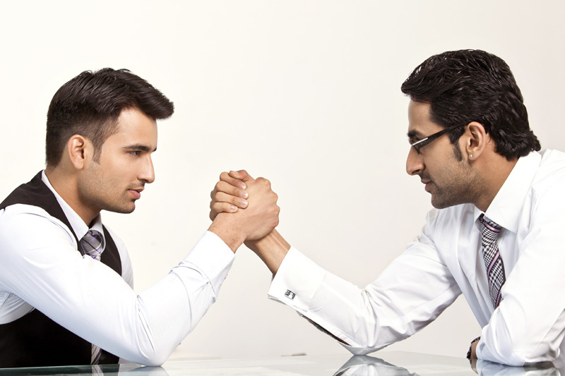 two businessman arm wrestling