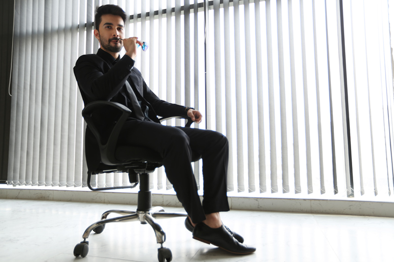 man in formals sitting on chair