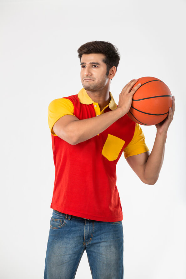 guy looking away with basketball in his hands 