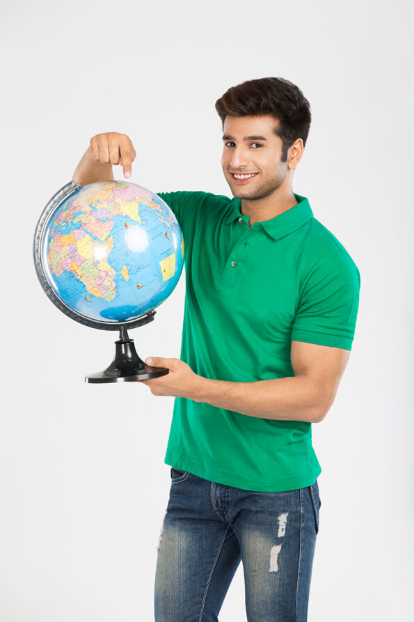 man showing globe while smiling 