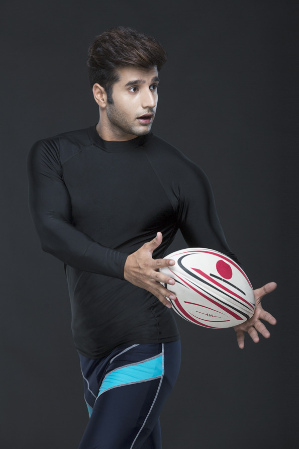 man in action while playing with rugby ball