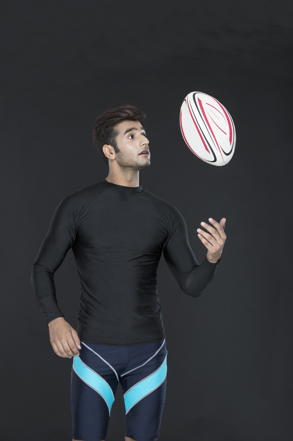 man in sports wear playing with rugby ball