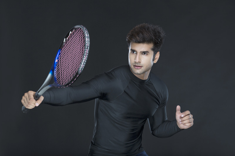 man posing as tennis player