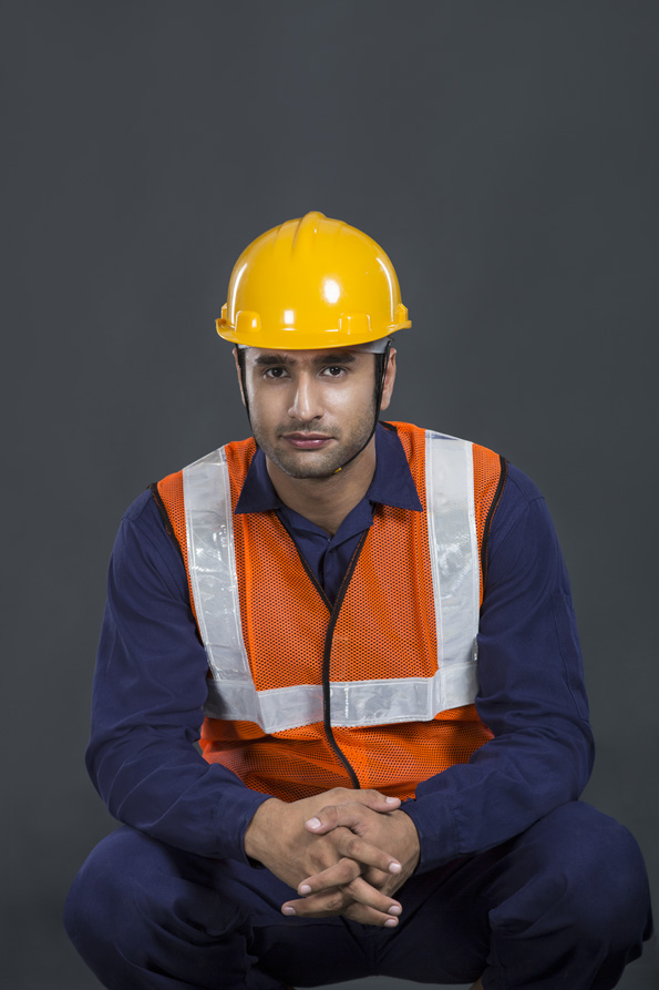 construction man sitting and posing wearing hardhat