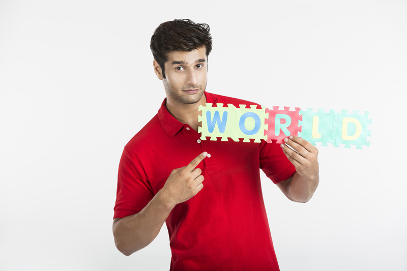 guy pointing towards letter made from jigsaw puzzle 