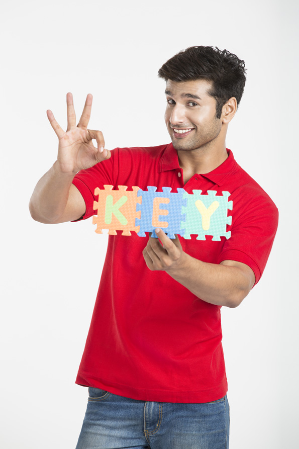 guy holding jigsaw puzzle and showing ok sign with hand