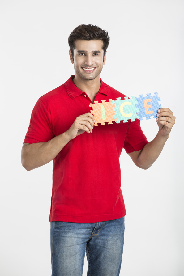 guy smiling while holding a jigsaw puzzle