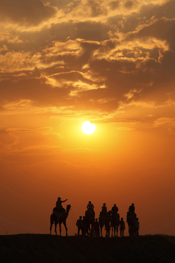tourists taking camel ride