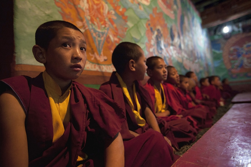 buddhist children sitting in a row in the classroom