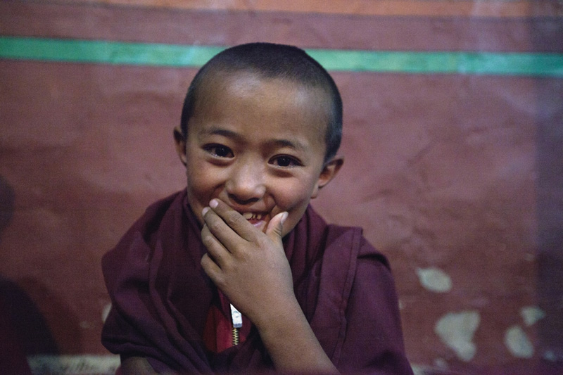monk child at the monastery smiling 