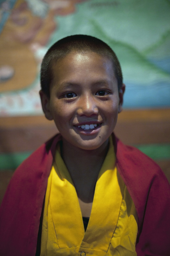 buddhist child smiling while posing for the camera  