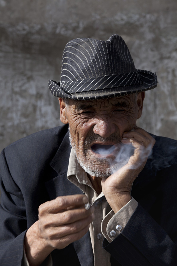 old ladakhi man having cigarette puff 