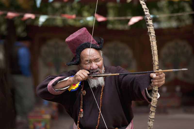 old ladakhi man practicing archery 