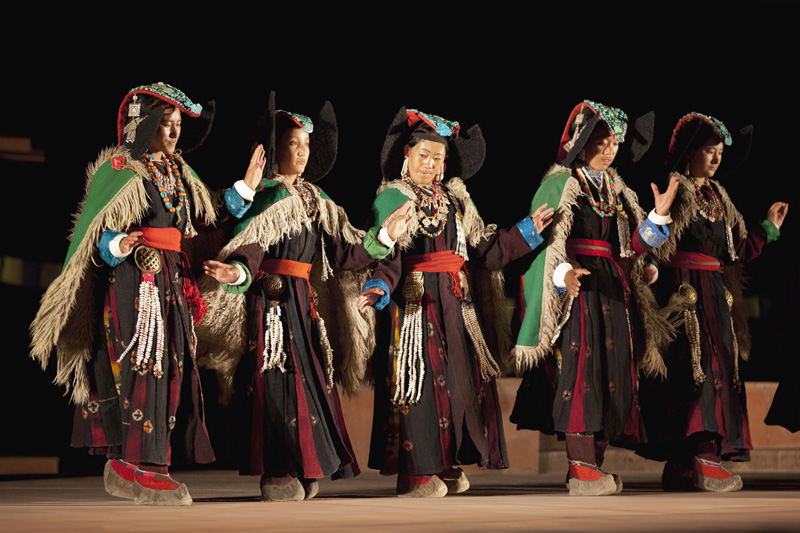 women performing folk dance at the local festival in ladakh