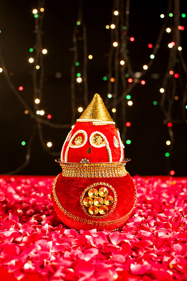 decorated kalash with lighting in background