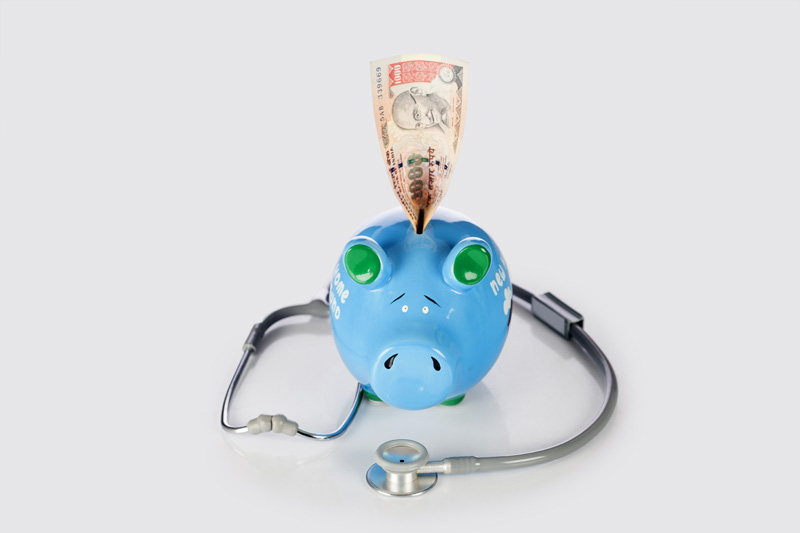 piggy bank with  stethoscope and money