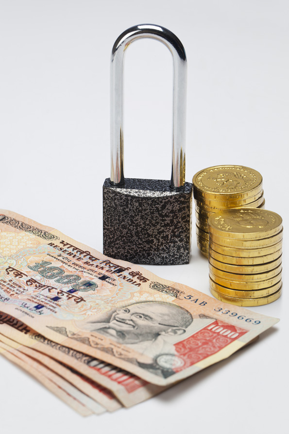 cash and gold coins with lock